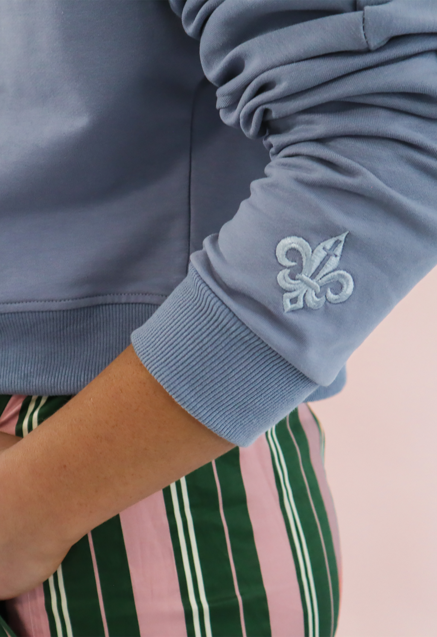 Close up of sleeve showing embroidered detail of Saint Liberté logo